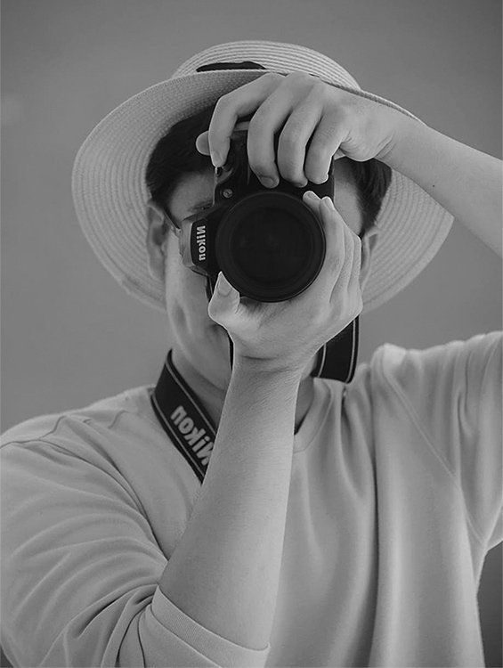 Professional photographer capturing a photo with DSLR camera, representing media coverage and brand visibility by a PR Agency in India.